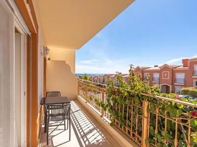 a balcony of a condo with a table and chairs at Relax and golf at Boavista Golf Spa Resort #1968 in Lagos