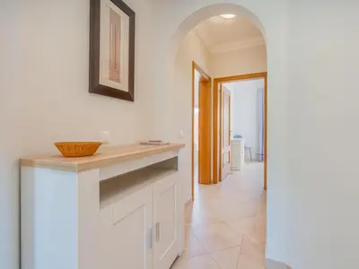 a kitchen with white cabinets and a wooden counter at Relax and golf at Boavista Golf Spa Resort #1968 in Lagos