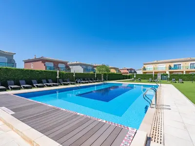 a swimming pool in a villa with chairs at Relax and golf at Boavista Golf Spa Resort #1968 in Lagos