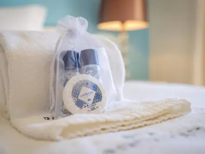 a bag of toothbrushes sitting on a bed at Relax and golf at Boavista Golf Spa Resort #1968 in Lagos