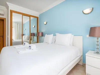 a bedroom with a large white bed with a mirror at Relax and golf at Boavista Golf Spa Resort #1968 in Lagos