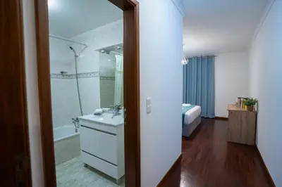 a bathroom with a sink and a shower and a tub at Apartamento Isabel Charmoso e bem localizado in Ribeira Brava