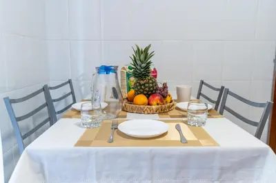 a table with a bowl of fruit on top of it at Apartamento Isabel Charmoso e bem localizado in Ribeira Brava