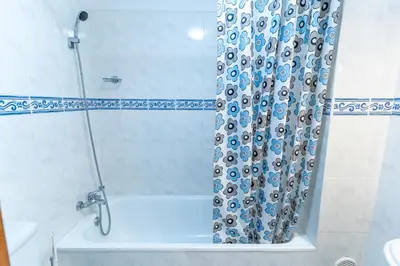 a shower curtain in a bathroom with a tub at Apartamento Isabel Charmoso e bem localizado in Ribeira Brava