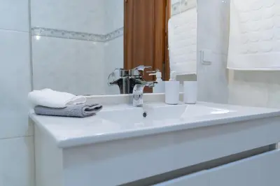 a bathroom with a sink and a mirror at Apartamento Isabel Charmoso e bem localizado in Ribeira Brava