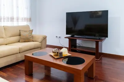 a living room with a couch and a coffee table at Apartamento Isabel Charmoso e bem localizado in Ribeira Brava