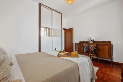 a bedroom with a bed with a tray of fruit on it at Casa Nóbrega, By OP in Funchal