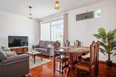 a living room with a table and a couch at Casa Nóbrega, By OP in Funchal