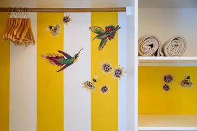 a room with two birds on a yellow wall at Casa Velha da Lagoa - Pássaro - by Mth in Ponta do Sol