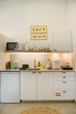 a kitchen with white cabinets and a sink at Casa Velha da Lagoa - Pássaro - by Mth in Ponta do Sol