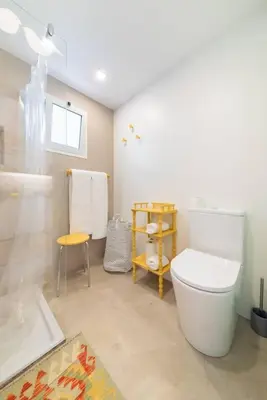 a bathroom with a white toilet and a sink at Casa Velha da Lagoa - Pássaro - by Mth in Ponta do Sol