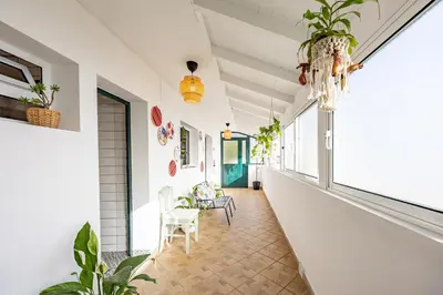 a hallway of a house with plants and a chandelier at Hibiscus House by YOUR KEY in Calheta