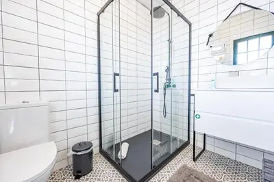 a bathroom with a glass shower with a toilet at Hibiscus House by YOUR KEY in Calheta