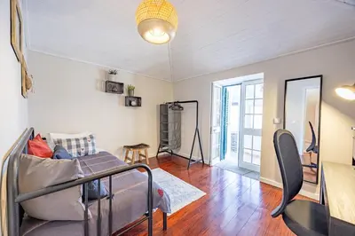 a living room with a couch and a table at Hibiscus House by YOUR KEY in Calheta