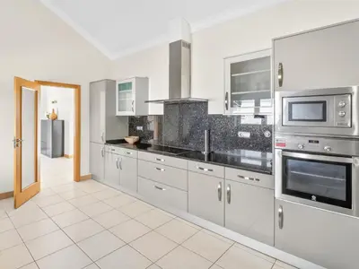a kitchen and dining room with a table and chairs at Vila Limoeiro in Lagos