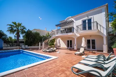 a swimming pool on a patio with a fence at Vila Limoeiro in Lagos