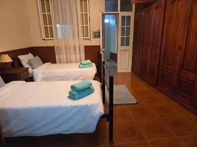 a room with two beds with towels on them at Villa Pedro, Big House in Calheta