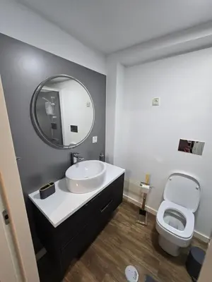 a bathroom with a sink and a toilet and a mirror at Zen Space in Funchal