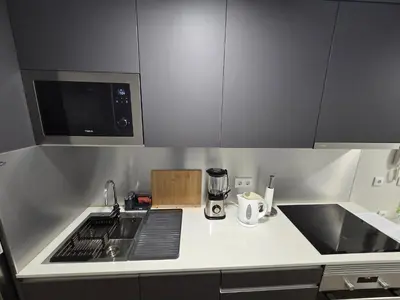 a kitchen with a sink and a stove top oven at Zen Space in Funchal
