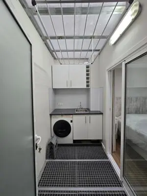 a small kitchen with a sink and a bed in a room at Zen Space in Funchal