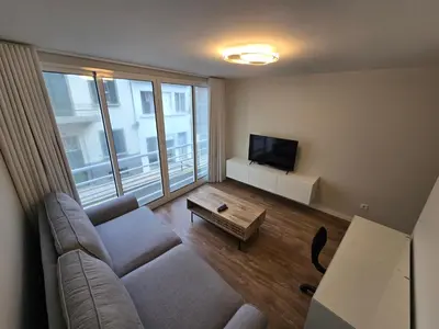 a living room with a couch and a flat screen tv at Zen Space in Funchal