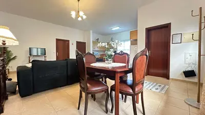 a dining room with a table and chairs and a couch at Sea and Sun 4 You - Villa Jardim in Santana