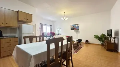 a kitchen and living room with a table and chairs at Sea and Sun 4 You - Villa Jardim in Santana