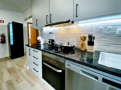 a kitchen with a counter top and a refrigerator at VilaMar in Salema