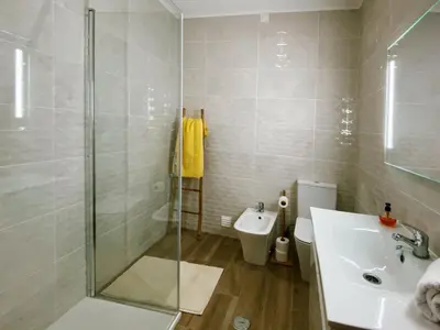 a bathroom with a shower and a sink and a toilet at VilaMar in Salema