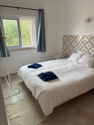 a kitchen with white cabinets and a sink at Quinta Madrugada Burgau in Luz