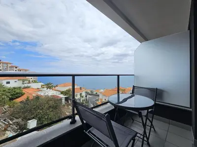 a balcony with a table and chairs and a view at Vista Mar Garajau II by Rentallido in Caniço