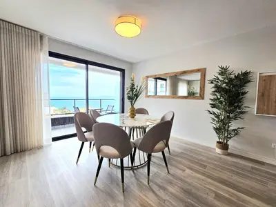 a dining room with a table and chairs at Vista Mar Garajau II by Rentallido in Caniço
