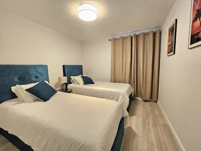 a hotel room with two beds in a room at Vista Mar Garajau II by Rentallido in Caniço