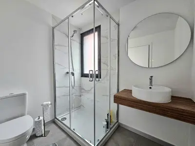 a bathroom with a shower and a sink and a mirror at Vista Mar Garajau II by Rentallido in Caniço
