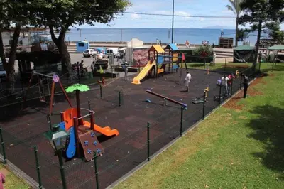 a park with a playground with people playing on it at Paraíso Altântico in Machico