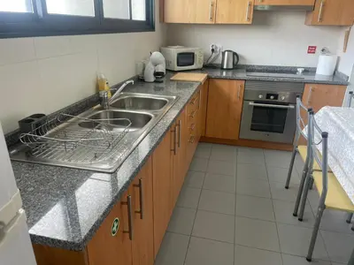a kitchen with a sink and a microwave at Paraíso Altântico in Machico