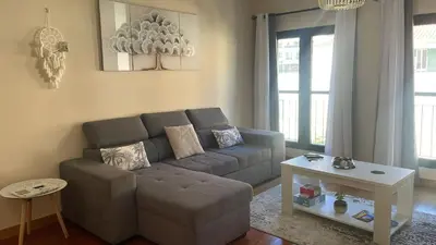 a living room with a couch and a table at Paraíso Altântico in Machico