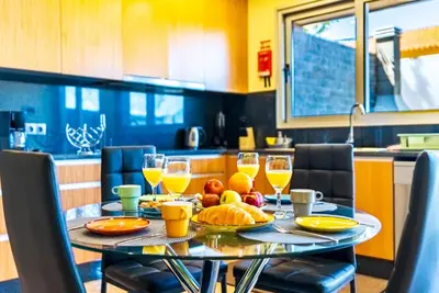 a table with a plate of food on it in a kitchen at Quinta do Til in Prazeres