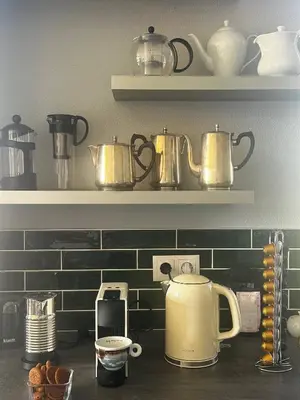 a kitchen counter with pots and pans on shelves at Miguels Seaview Corner in Ponta do Sol