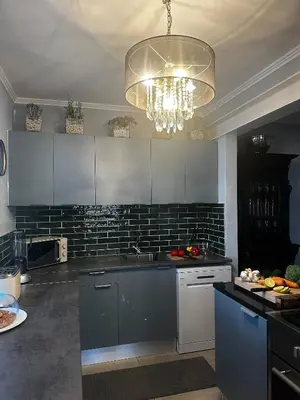 a kitchen with a sink and a chandelier at Miguels Seaview Corner in Ponta do Sol
