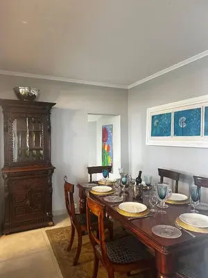 a dining room with a wooden table and chairs at Miguels Seaview Corner in Ponta do Sol
