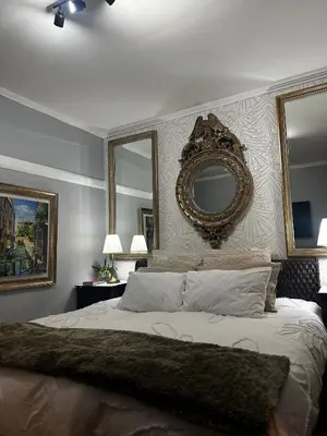 a bedroom with a large bed with a mirror on the wall at Miguels Seaview Corner in Ponta do Sol