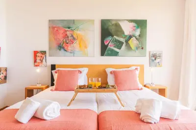 a bedroom with a bed with a tray of food on it at Cape View Villa by Atlantic Holiday in Ponta do Pargo