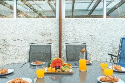 a table with a tray of food and orange juice at Cape View Villa by Atlantic Holiday in Ponta do Pargo