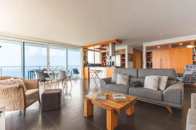a living room with a couch and a table at Cape View Villa by Atlantic Holiday in Ponta do Pargo
