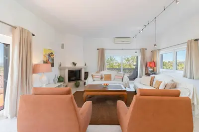 a living room with two chairs and a couch at Casa Tambeim in Montinhos da Luz