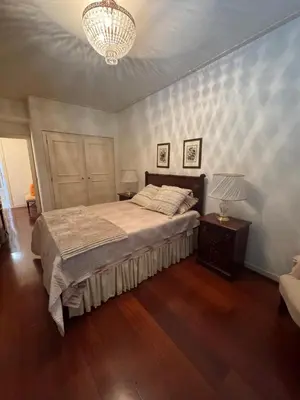 a bedroom with a bed and a chandelier at Infante Santo Holidays in Funchal