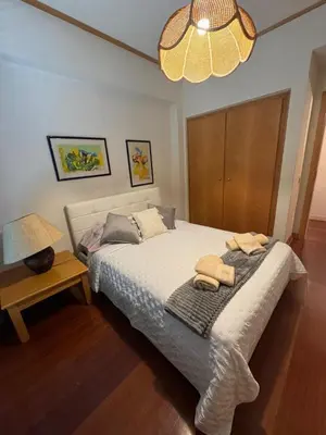 a bedroom with a bed with two towels on it at Infante Santo Holidays in Funchal