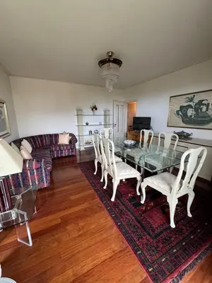a living room with a glass table and chairs at Infante Santo Holidays in Funchal