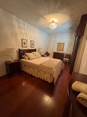 a bedroom with a bed and a chandelier at Infante Santo Holidays in Funchal